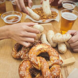 Saucisses blanches bouillies, servies avec de la bière et des bretzels.