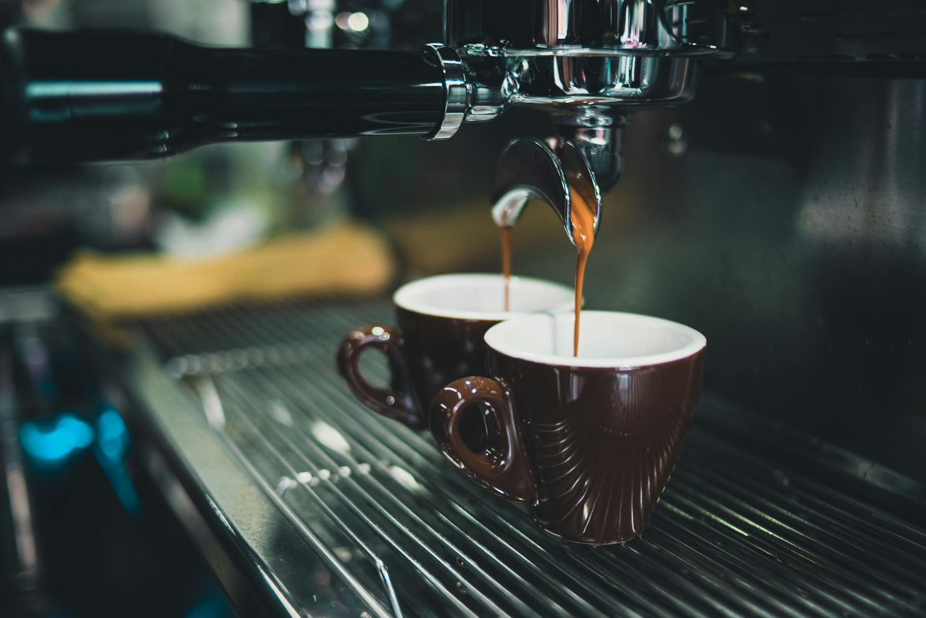 Gros plan d'une machine à expresso professionnelle préparant du café en tasses.